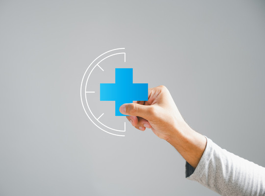 Hand holding medical symbol 