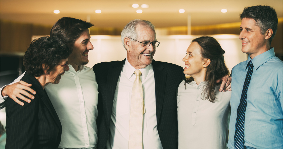 Man with his grown kids smiling